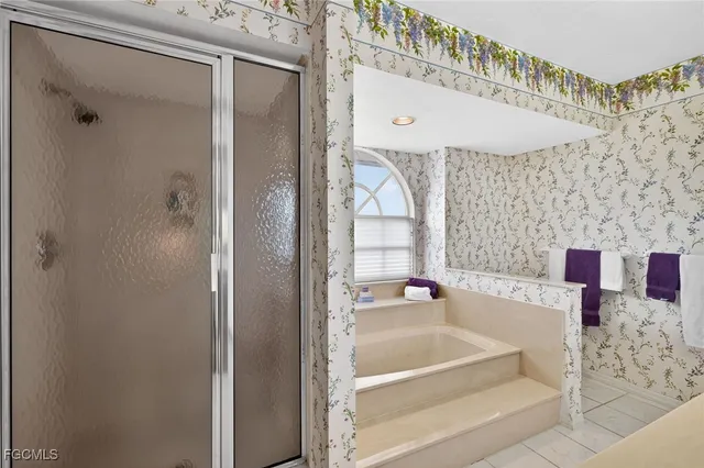 a bathroom with a bathtub and a shower