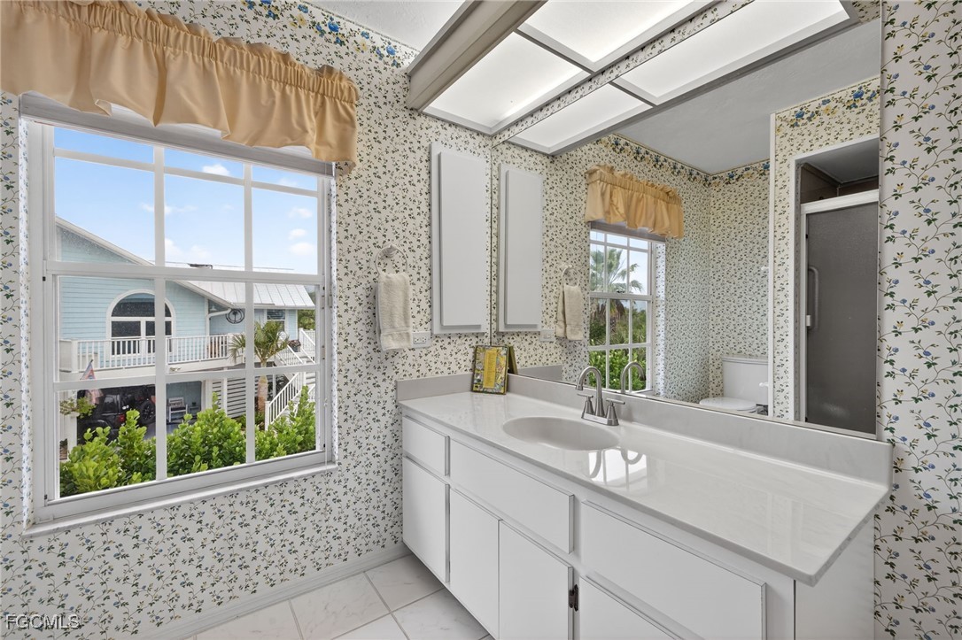 966 Sand Castle Road Sanibel, FL 33957 - Photo 21 of 39 a bathroom with a sink and a mirror