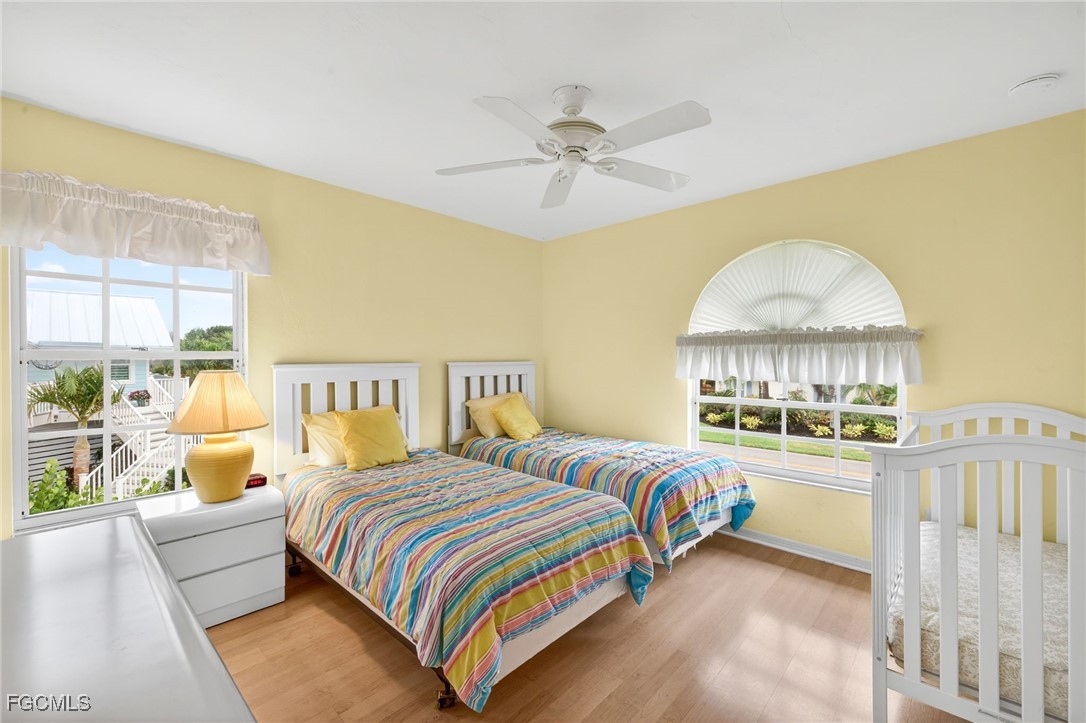 966 Sand Castle Road Sanibel, FL 33957 - Photo 22 of 39 a bedroom with a bed and a chandelier