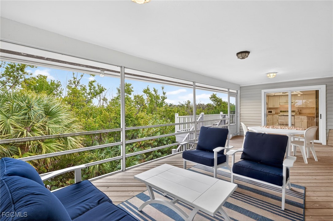966 Sand Castle Road Sanibel, FL 33957 - Photo 27 of 39 a living room with furniture and a large window
