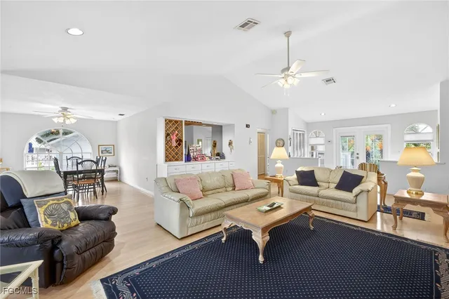 a living room with furniture a rug and a chandelier