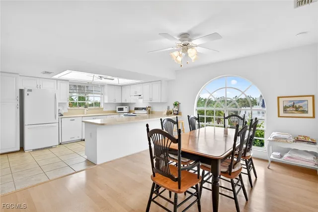 a dining room with furniture a window and wooden floor