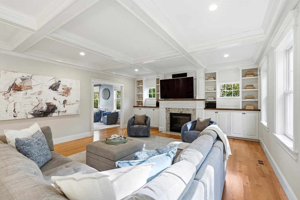 6 Flintlock Road Lexington, MA 02420 - Photo 4 of 39 a living room with furniture a fireplace and a flat screen tv