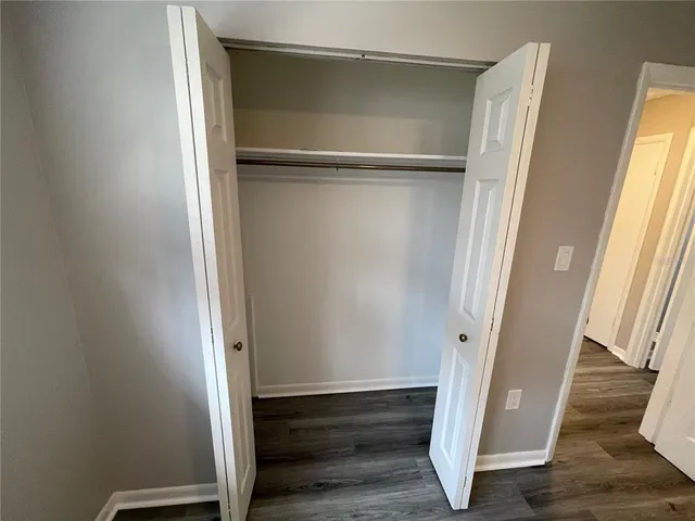a view of a room with wooden floor