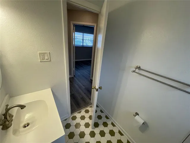 a bathroom with a sink mirror toilet and shower