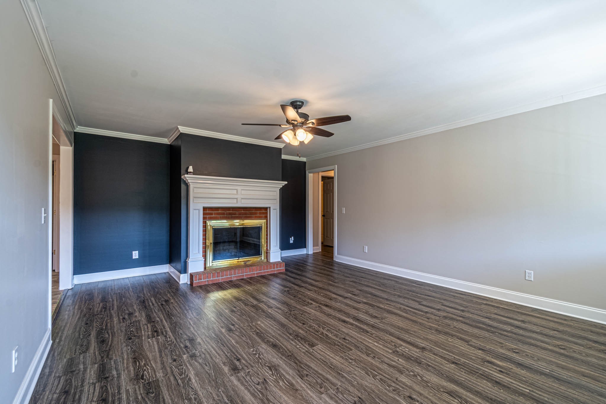 1316 Powdermill Hill Road Lawrenceburg, TN 38464 - Photo 4 of 70 a view of an empty room with wooden floor fireplace and a window