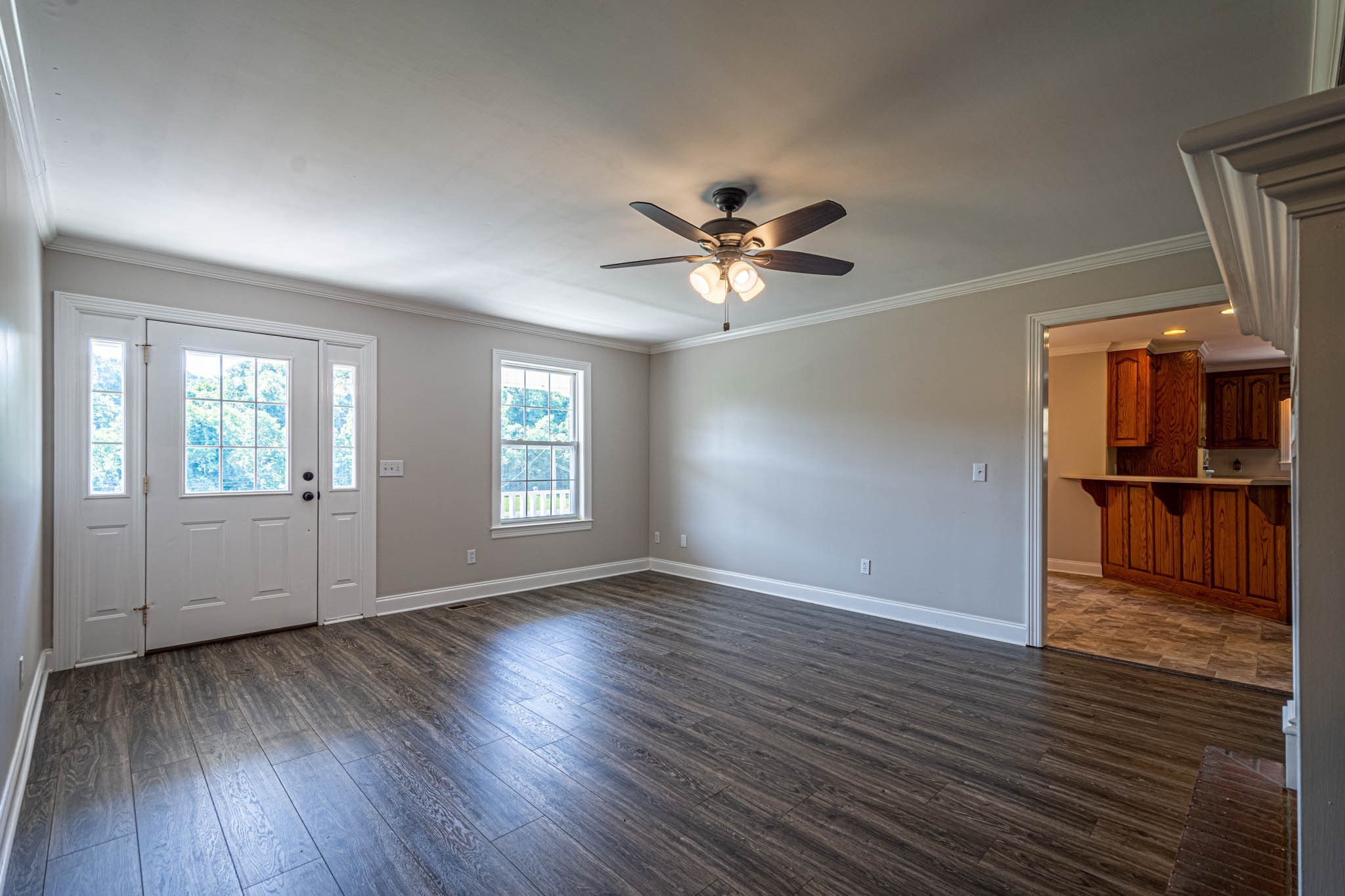 1316 Powdermill Hill Road Lawrenceburg, TN 38464 - Photo 6 of 70 an empty room with wooden floor and windows