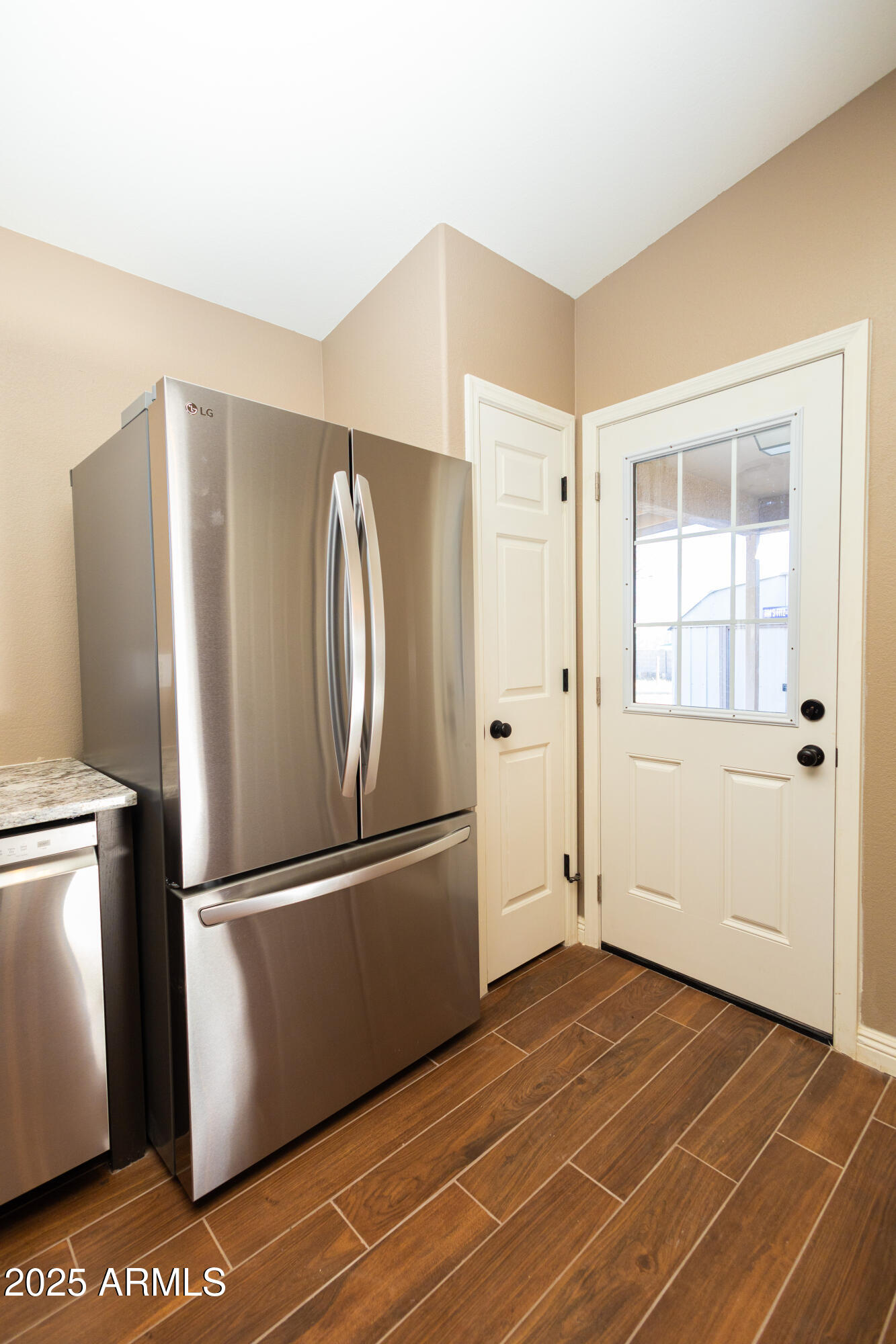 5837 South Wild Rose Road Hereford, AZ 85615 - Photo 12 of 46 a view of a refrigerator in kitchen and an empty room