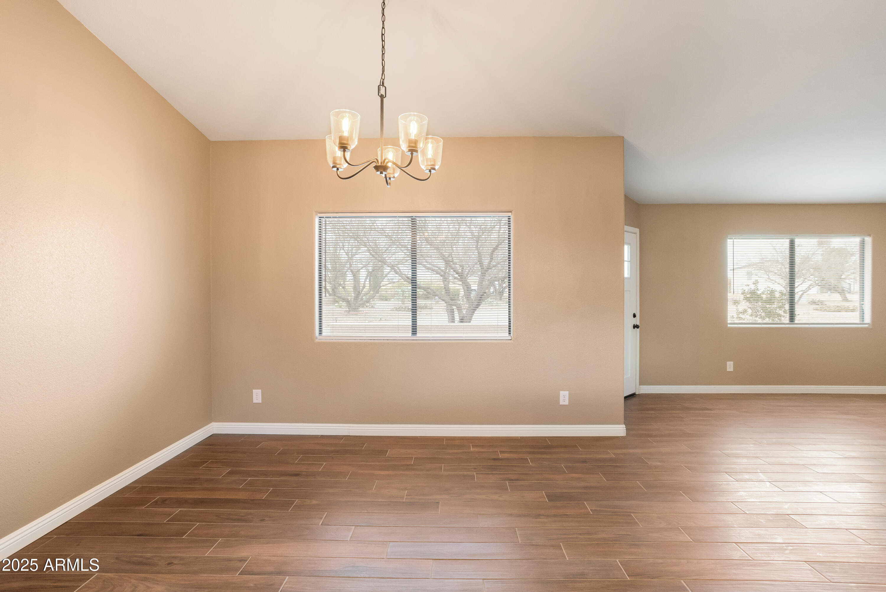 5837 South Wild Rose Road Hereford, AZ 85615 - Photo 17 of 46 a view of a room with wooden floor chandelier and windows
