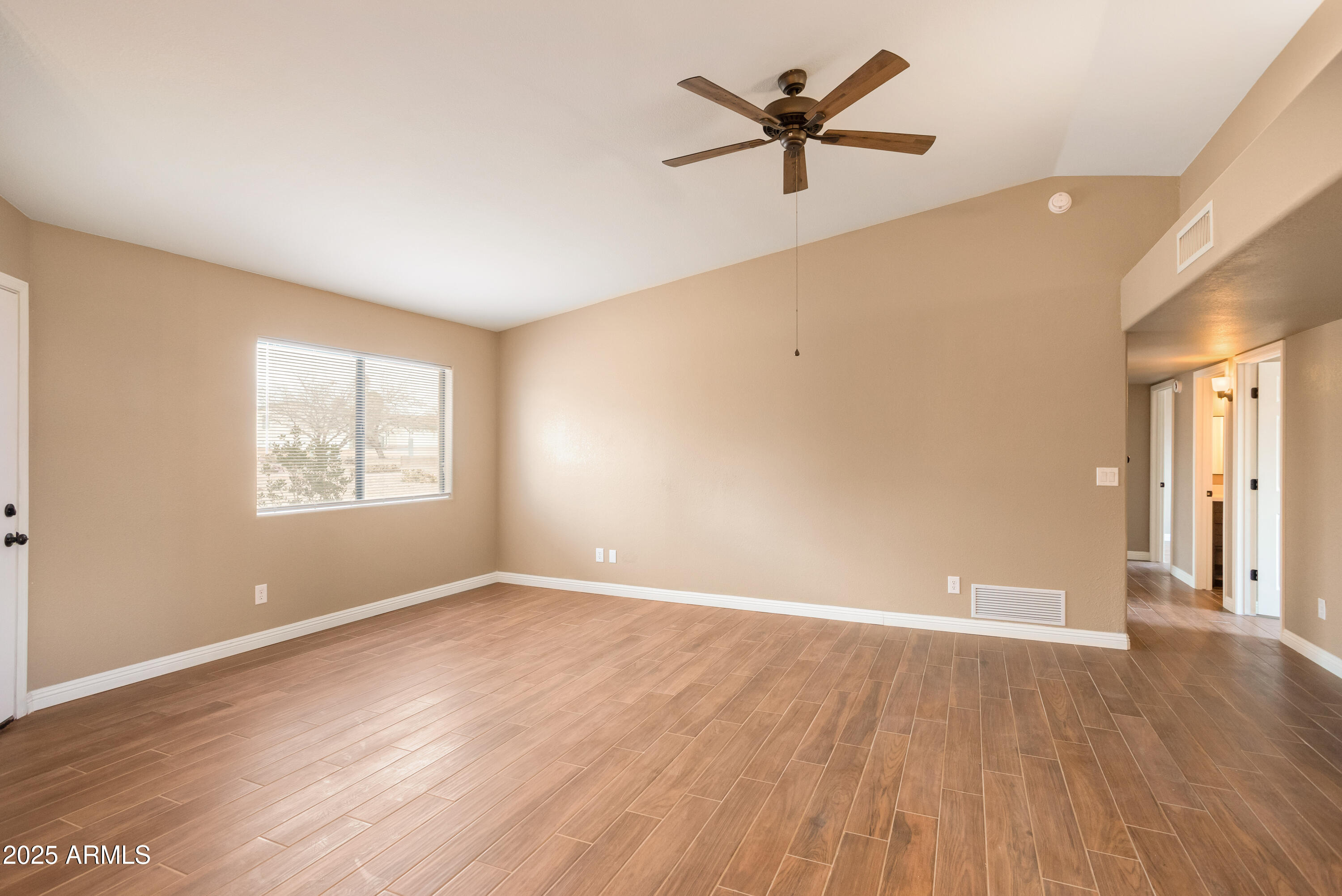 5837 South Wild Rose Road Hereford, AZ 85615 - Photo 18 of 46 an empty room with wooden floor and windows
