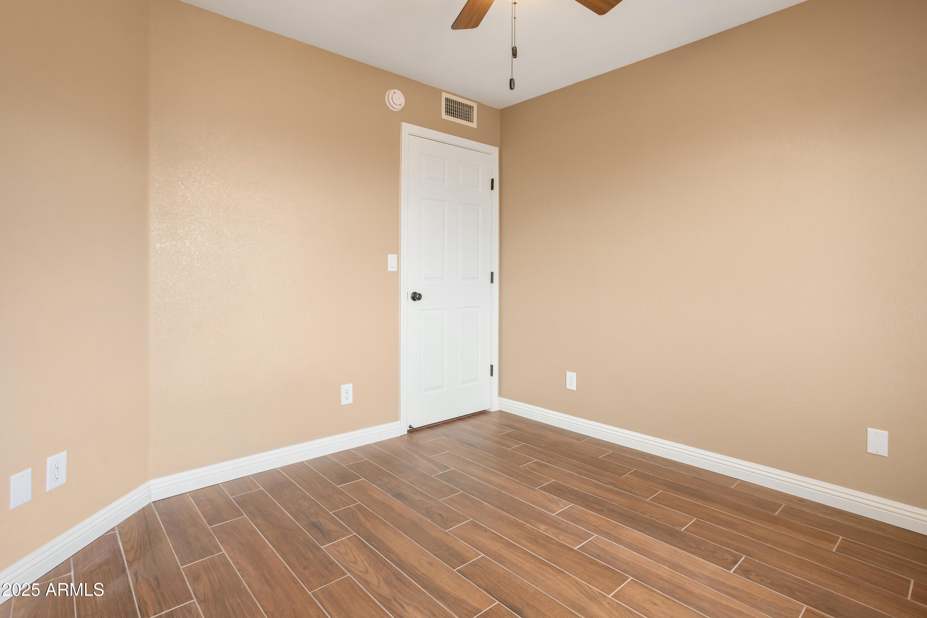 5837 South Wild Rose Road Hereford, AZ 85615 - Photo 21 of 46 a view of an empty room with wooden floor