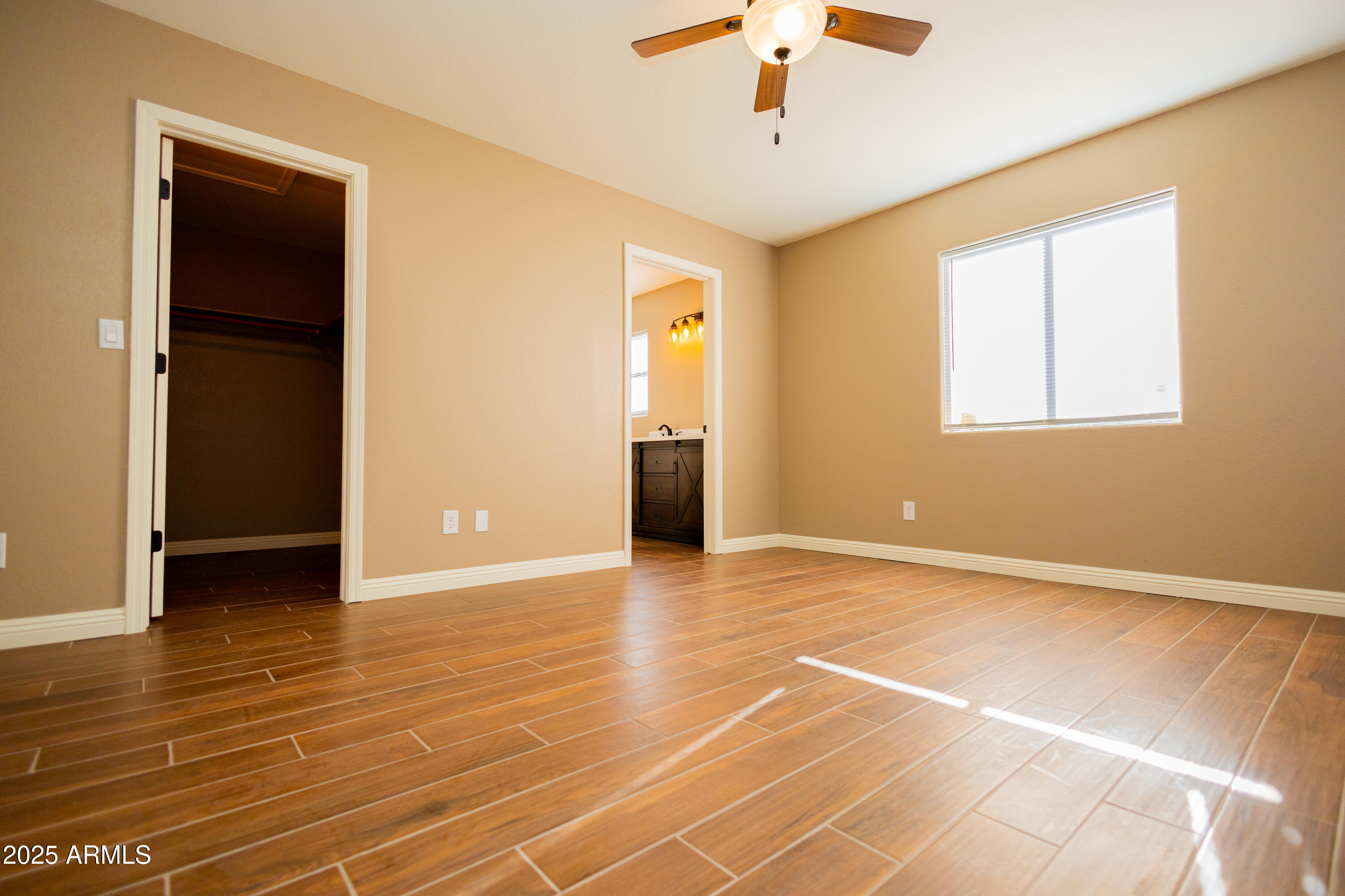 5837 South Wild Rose Road Hereford, AZ 85615 - Photo 28 of 46 an empty room with wooden floor chandelier and windows