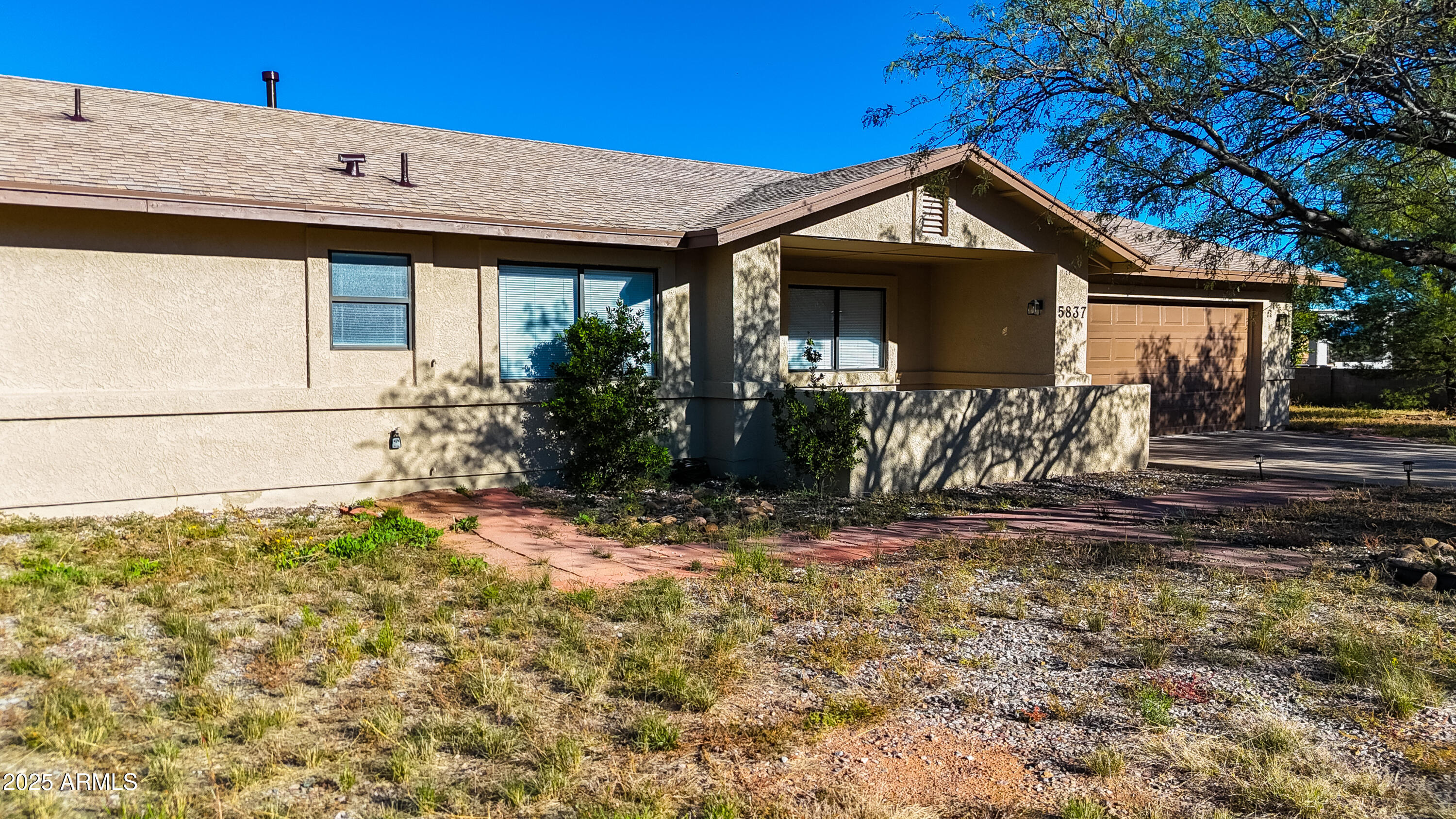 5837 South Wild Rose Road Hereford, AZ 85615 - Photo 42 of 46 a front view of a house with garden