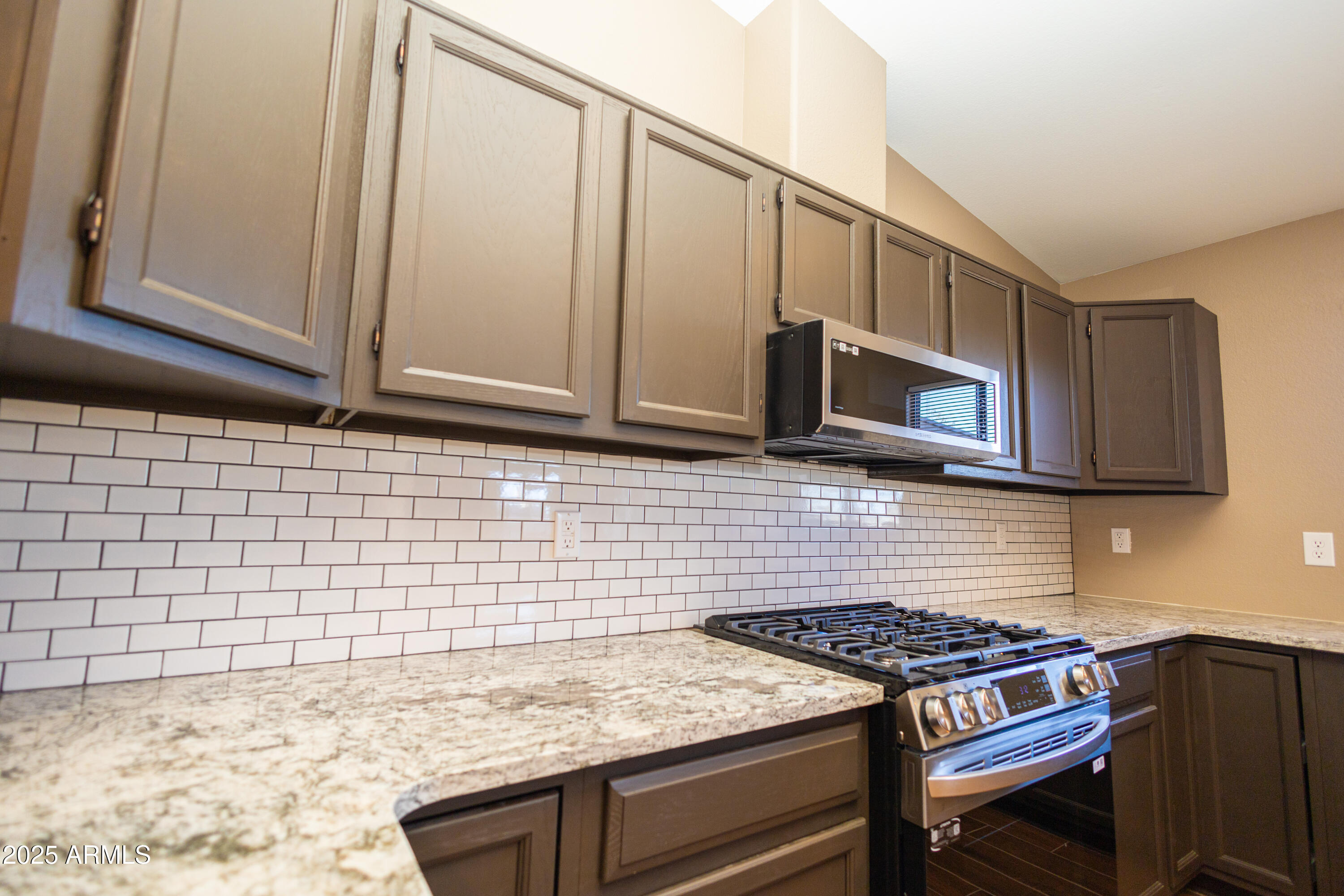 5837 South Wild Rose Road Hereford, AZ 85615 - Photo 8 of 46 a kitchen with granite countertop cabinets and steel stainless steel appliances