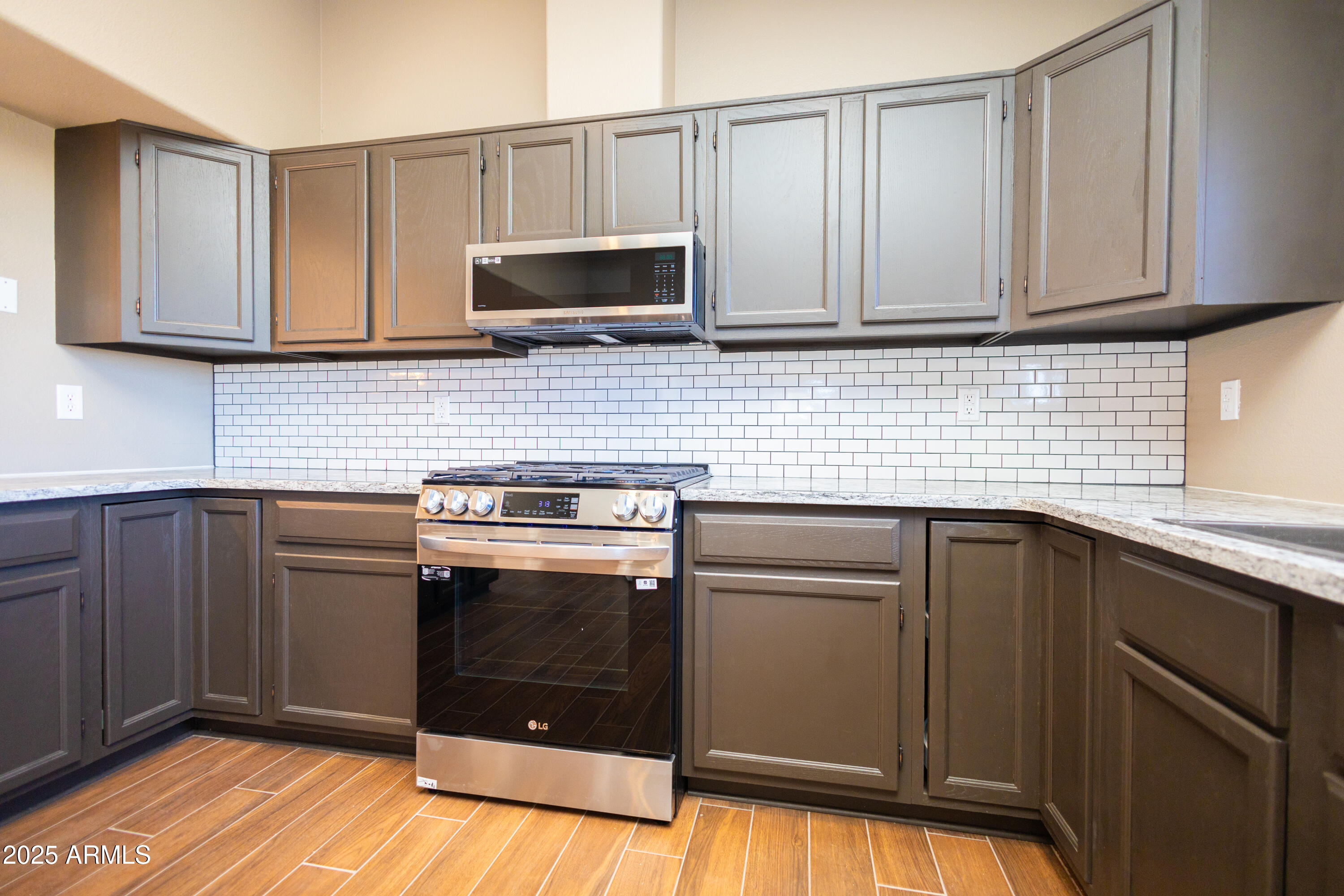 5837 South Wild Rose Road Hereford, AZ 85615 - Photo 10 of 46 a kitchen with granite countertop cabinets stainless steel appliances and a sink
