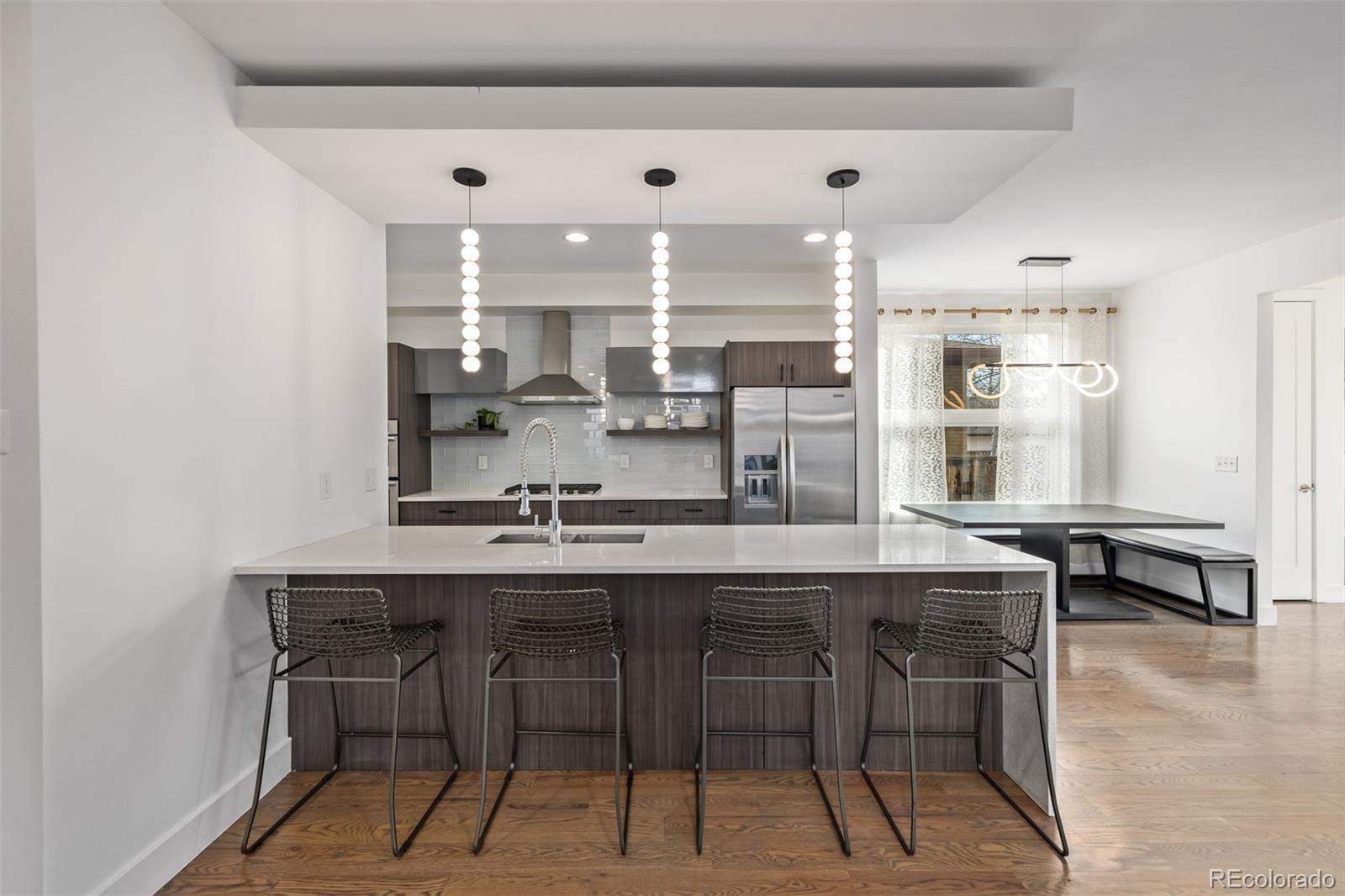 2245 Meade Street Denver, CO 80211 - Photo 11 of 40 a kitchen with stainless steel appliances kitchen island granite countertop a sink and cabinets