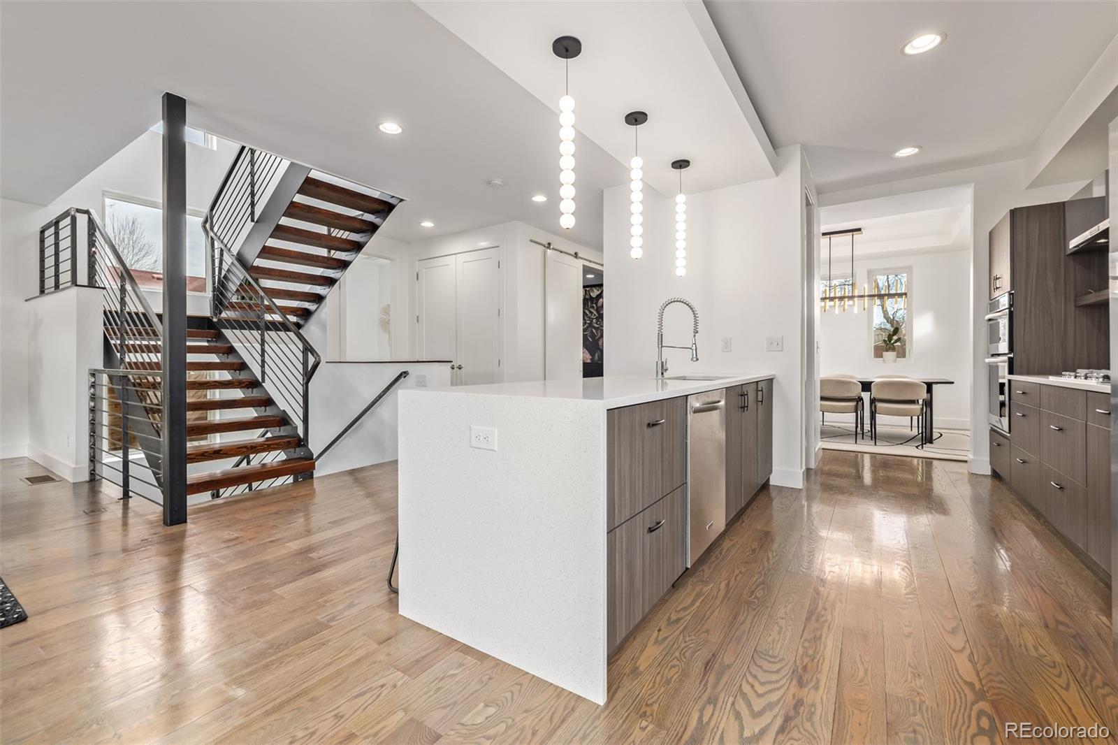 2245 Meade Street Denver, CO 80211 - Photo 15 of 40 a kitchen with sink cabinets and wooden floor