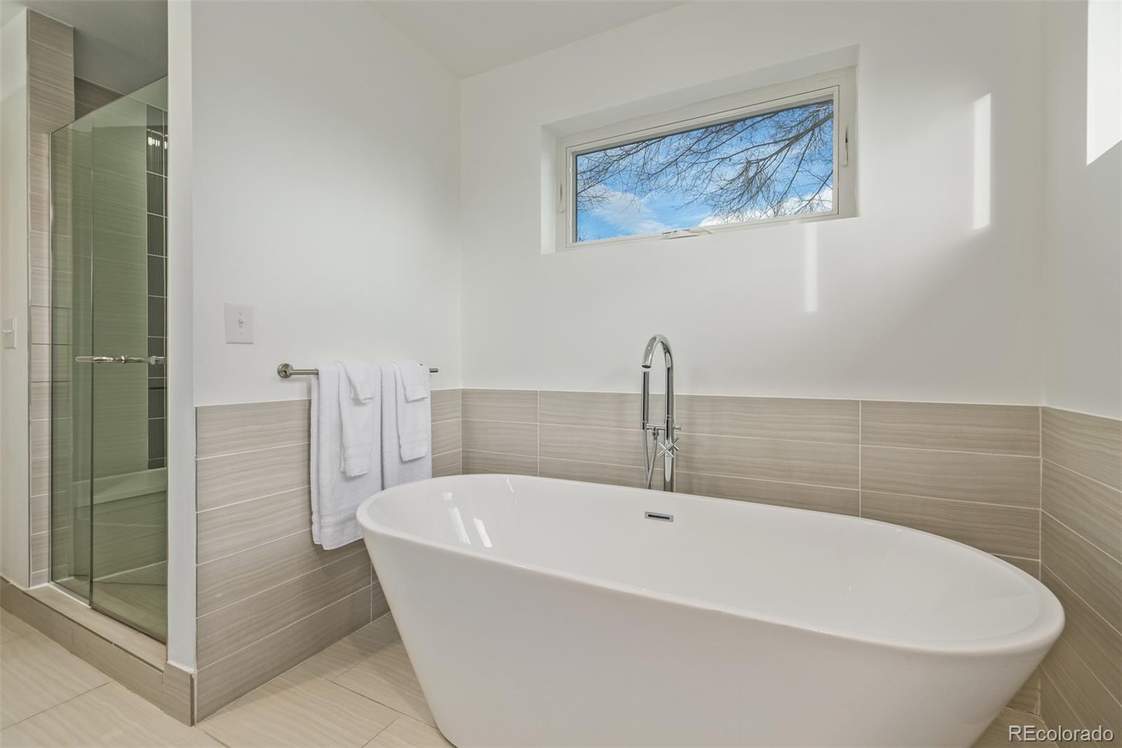 2245 Meade Street Denver, CO 80211 - Photo 19 of 40 a white bath tub sitting next to a bathroom sink