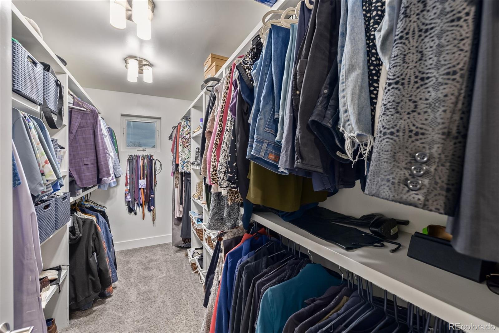 2245 Meade Street Denver, CO 80211 - Photo 21 of 40 a view of walk in closet with clothes and shoes