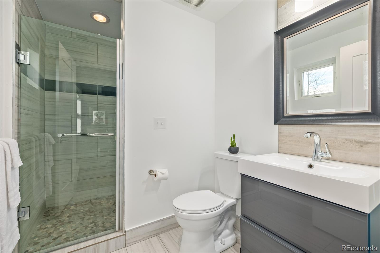 2245 Meade Street Denver, CO 80211 - Photo 27 of 40 a bathroom with a sink toilet and shower