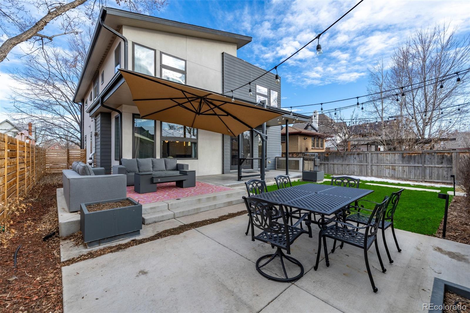 2245 Meade Street Denver, CO 80211 - Photo 35 of 40 a view of a patio with a table and chairs under an umbrella