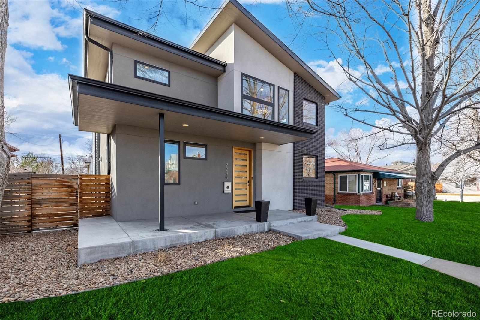 2245 Meade Street Denver, CO 80211 - Photo 38 of 40 a view of a brick house with many windows and a yard