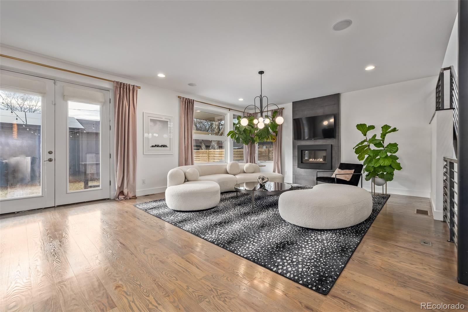 2245 Meade Street Denver, CO 80211 - Photo 6 of 40 a living room with furniture and a chandelier