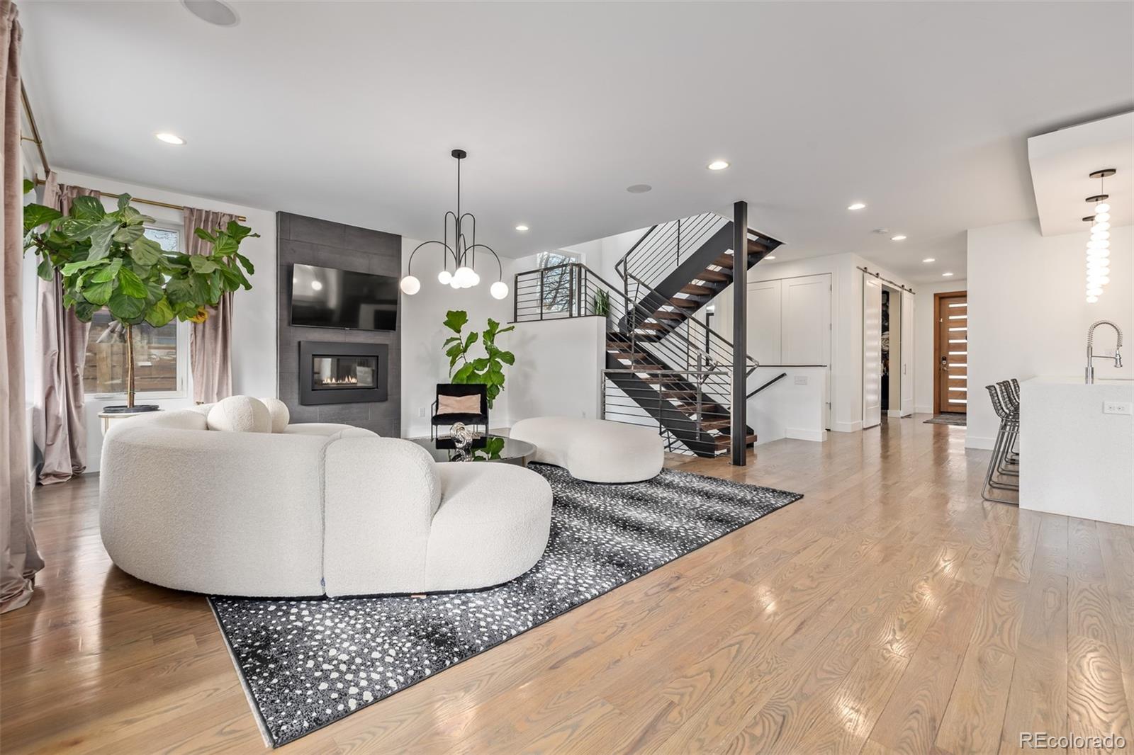2245 Meade Street Denver, CO 80211 - Photo 7 of 40 a living room with furniture and a chandelier