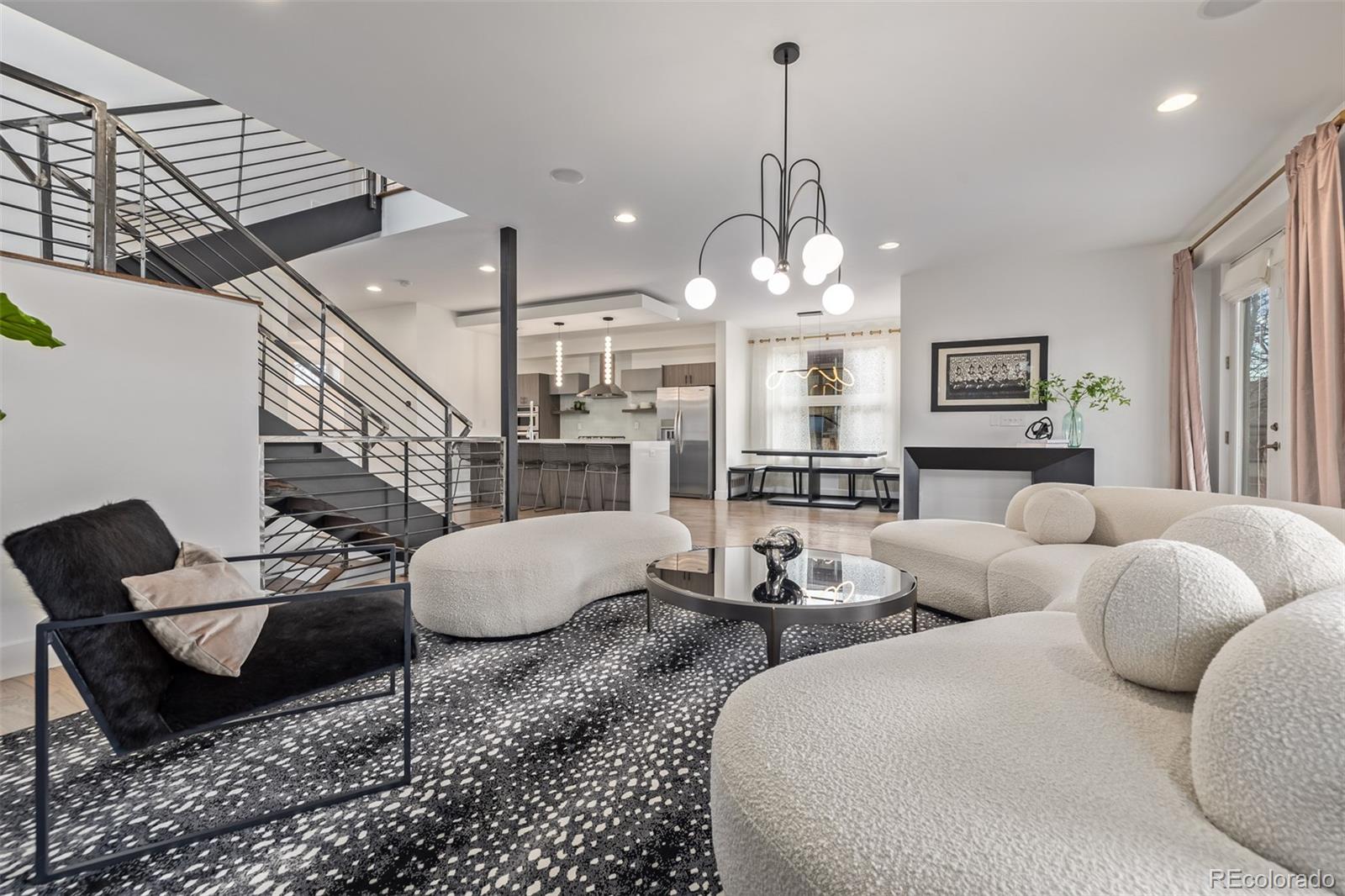 2245 Meade Street Denver, CO 80211 - Photo 8 of 40 a living room with furniture a chandelier and a rug