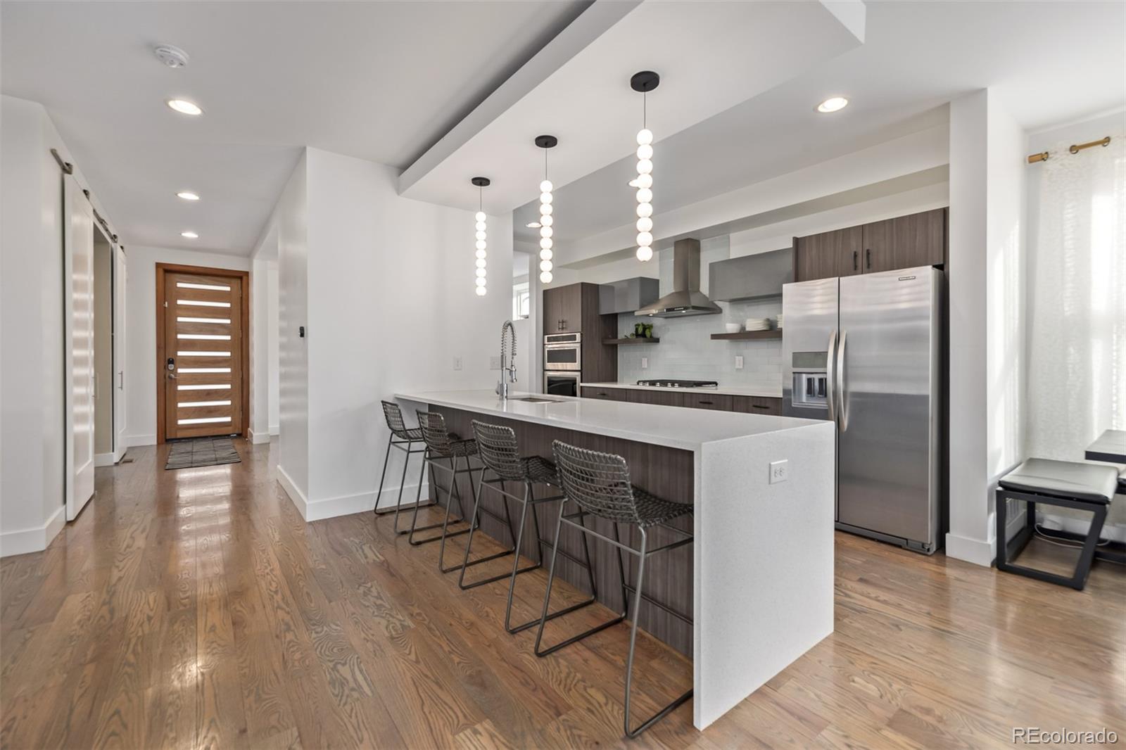 2245 Meade Street Denver, CO 80211 - Photo 9 of 40 a kitchen with kitchen island stainless steel appliances a sink and counter space