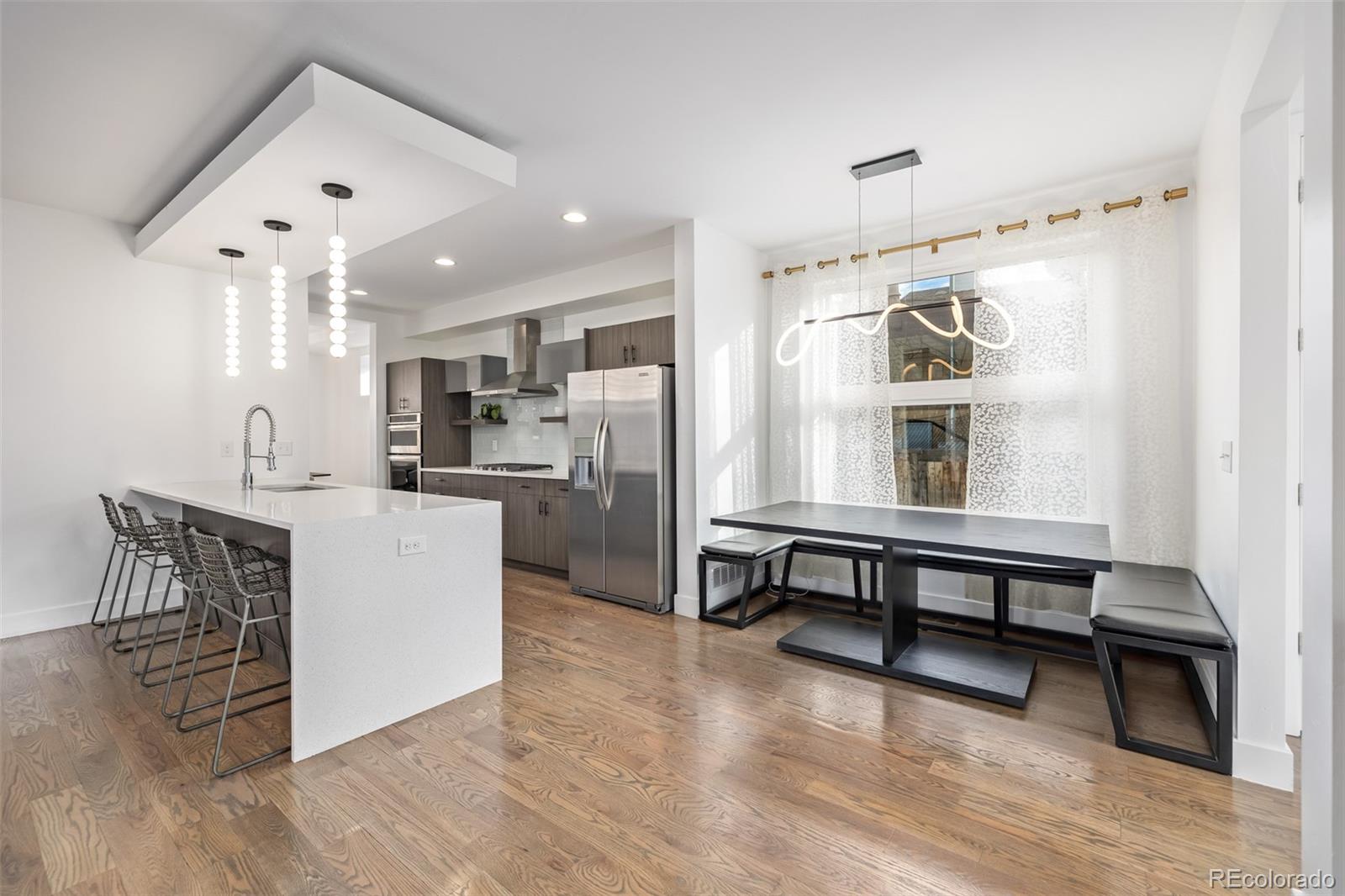 2245 Meade Street Denver, CO 80211 - Photo 10 of 40 a open kitchen with stainless steel appliances granite countertop a refrigerator and a stove top oven