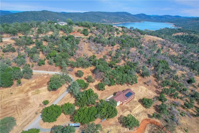 a aerial view of a house next to a yard