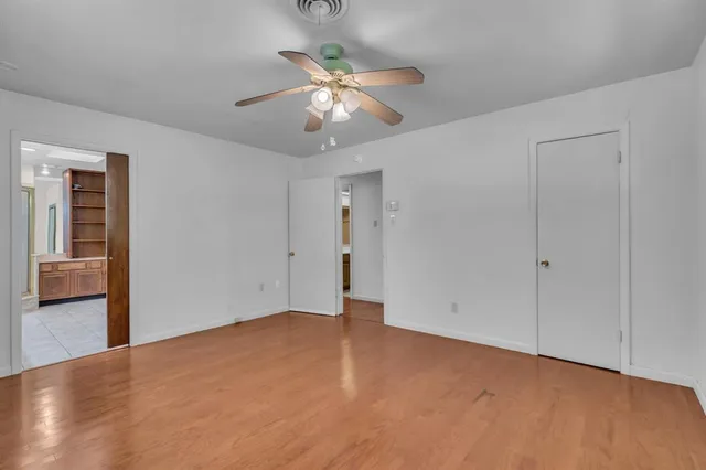 a view of an empty room with a ceiling fan