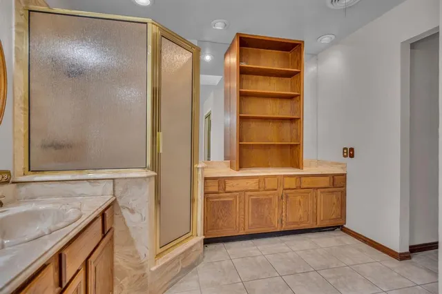 a bathroom with a granite countertop sink and a bathtub