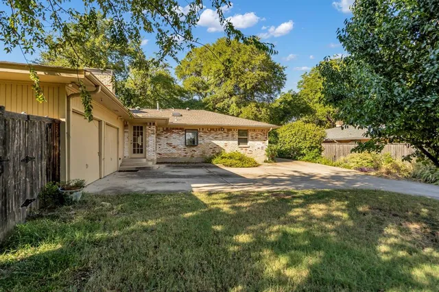 a view of a house with a yard and garage