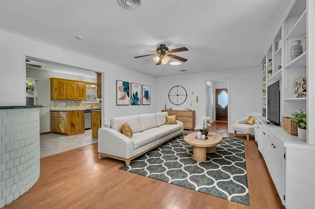 a living room with fireplace furniture and a wooden floor
