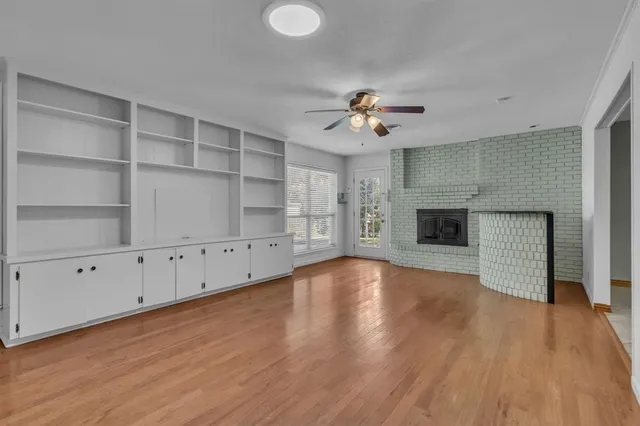 wooden floor in an empty room with a fireplace
