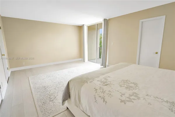 a bedroom with a bed and a mirror