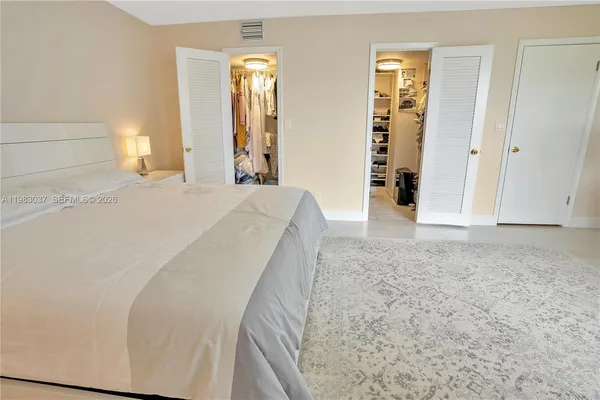 a view of a bedroom with wooden floor and stairs