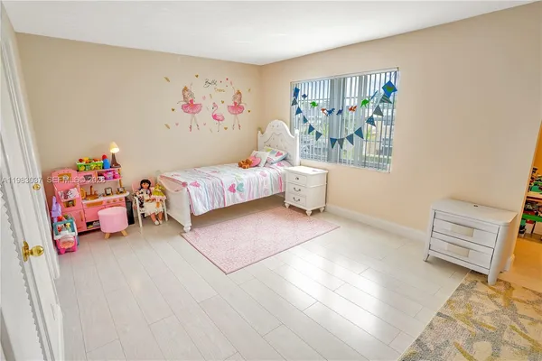 a living room with furniture and a baby crib