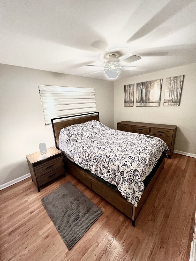602 West Central Road Arlington Heights, IL 60005 - Photo 12 of 22 a bed sitting in a bedroom next to a window with a dresser