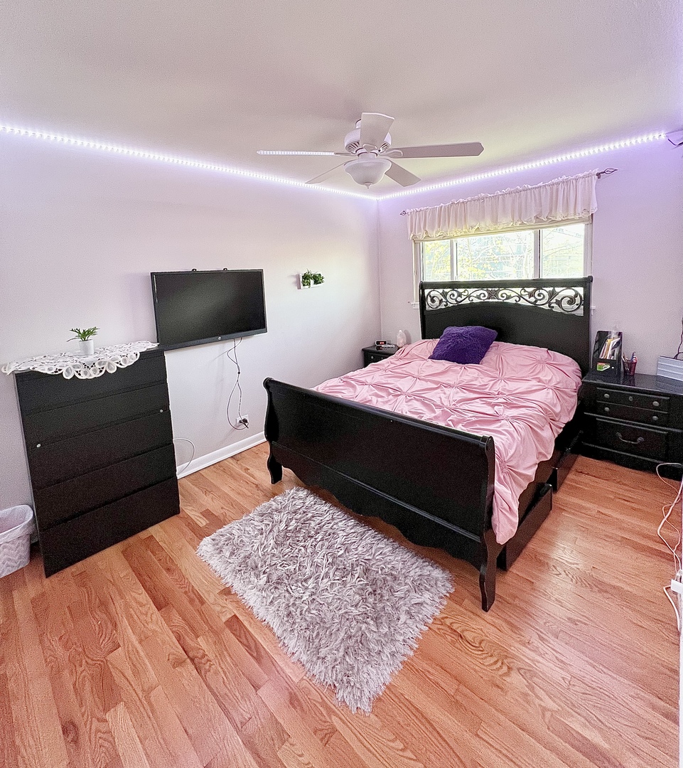 602 West Central Road Arlington Heights, IL 60005 - Photo 14 of 22 a bedroom with a bed and wooden floor