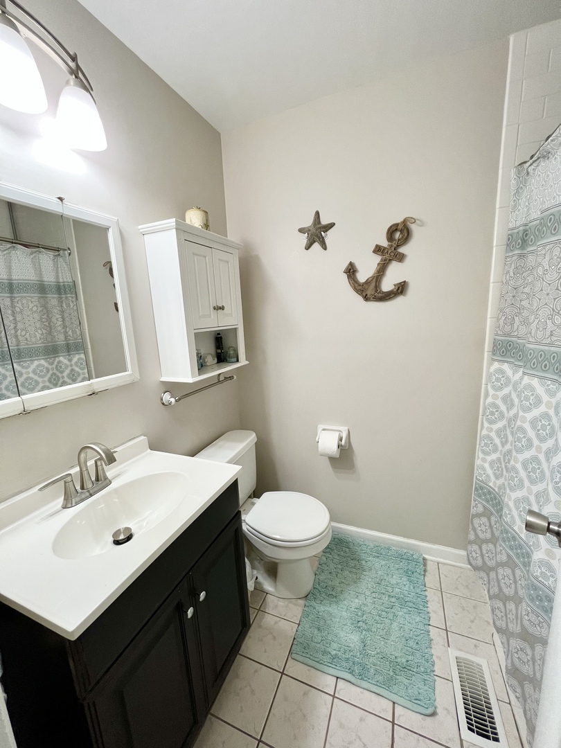 602 West Central Road Arlington Heights, IL 60005 - Photo 16 of 22 a bathroom with a sink mirror and toilet