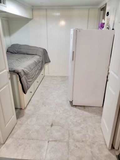 602 West Central Road Arlington Heights, IL 60005 - Photo 17 of 22 a bedroom with a bed and a refrigerator