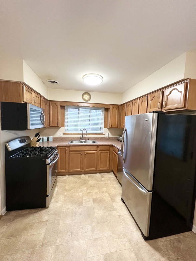 602 West Central Road Arlington Heights, IL 60005 - Photo 7 of 22 a kitchen with stainless steel appliances granite countertop a refrigerator and a stove