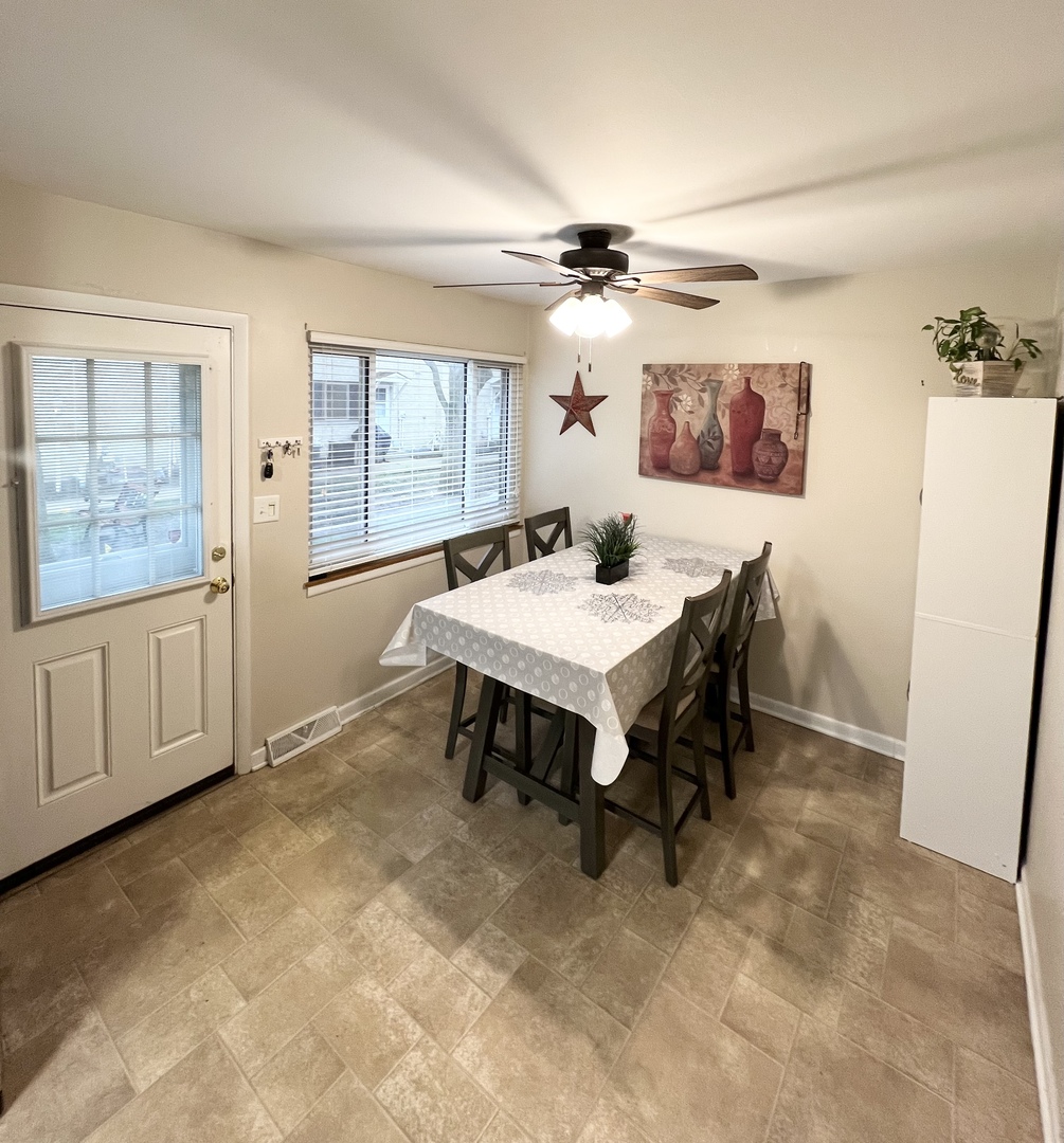 602 West Central Road Arlington Heights, IL 60005 - Photo 9 of 22 a view of a dining room with furniture window and wooden floor