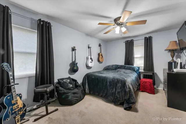 a bedroom with a bed and a chandelier