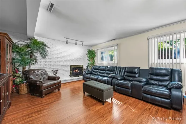 a living room with furniture window and wooden floor