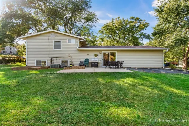 a front view of a house with a garden and patio