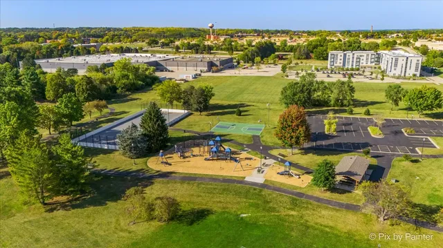 a backyard of a house with lots of green space and fountain